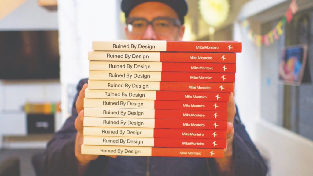 pic of author and stack of Ruined By Design